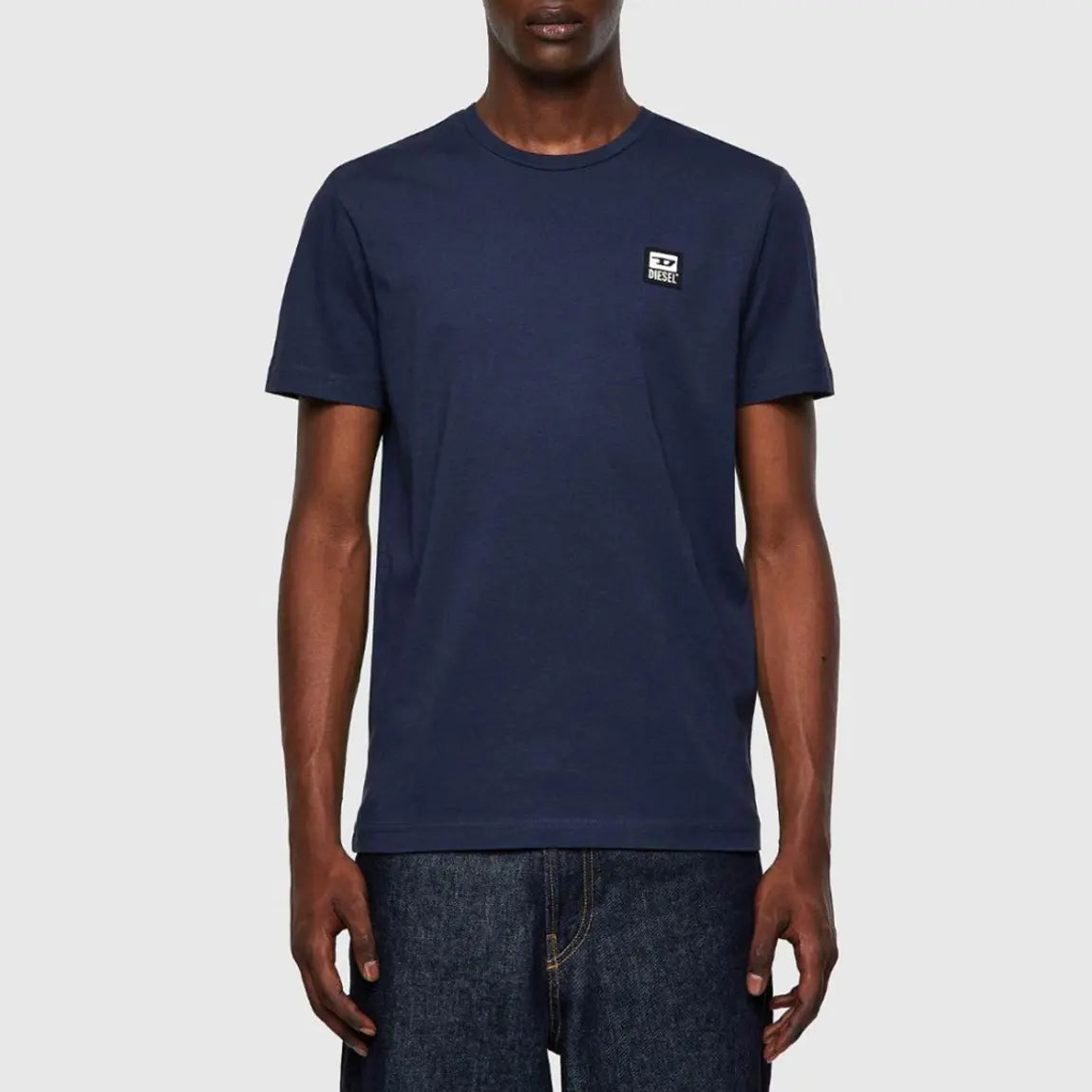 A black man with a diesel t-shirt on white background